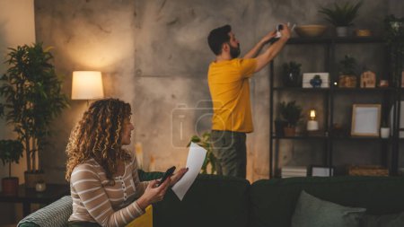 Photo for Couple at home connect and install cctv security surveillance camera - Royalty Free Image