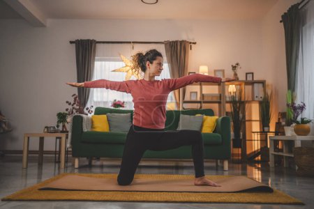 Photo for Woman caucasian female practice yoga on mat in living room at home - Royalty Free Image