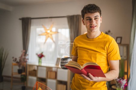 Photo for Young man caucasian teenager read book study at home education concept - Royalty Free Image