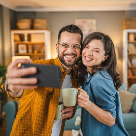Photo for Self portrait selfie of happy couple husband and wife boyfriend and girlfriend or brother and sister happy smile at home - Royalty Free Image