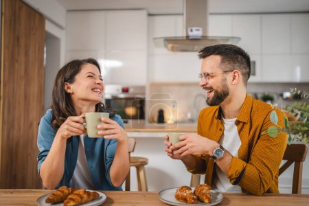 Photo for Adult couple have breakfast and cup of coffee at home morning routine - Royalty Free Image