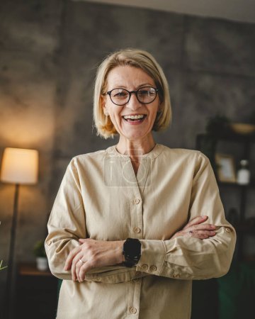 Photo for Portrait of one mature blonde caucasian woman with eyeglasses at home - Royalty Free Image