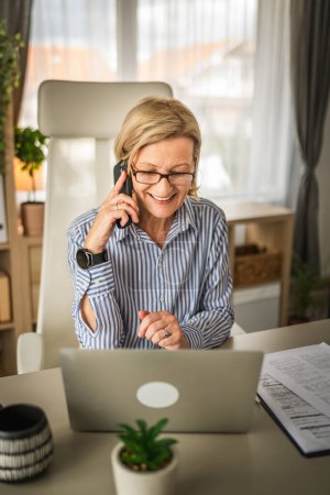 Photo for Mature woman business make a phone call at work talk happy smile - Royalty Free Image