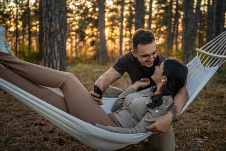 Photo for Man and woman young adult couple in nature in love sit together - Royalty Free Image