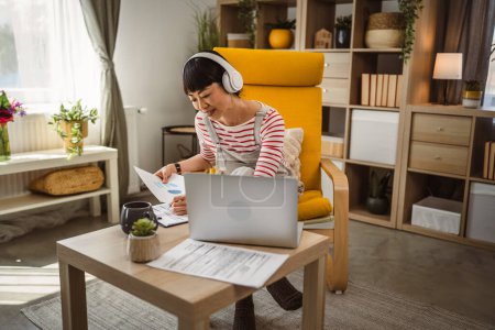 Photo for Japanese woman hold document contract work at home - Royalty Free Image