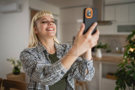 Photo for Adult woman take a selfie photo self portrait at home happy positive - Royalty Free Image