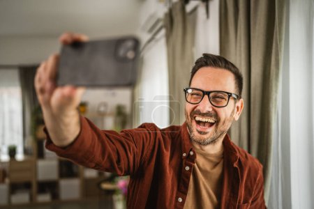 Portrait of adult caucasian man take a self portrait at home