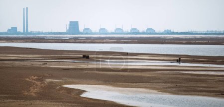 Photo for Terrible Disaster Ecocide landscape of dried up Kakhovka Reservoir in Zaporizhzhia region as a result of Kakhovka Dam damaging on 6 June 2023 with Zaporizhzhia thermal power station largest in Europe - Royalty Free Image