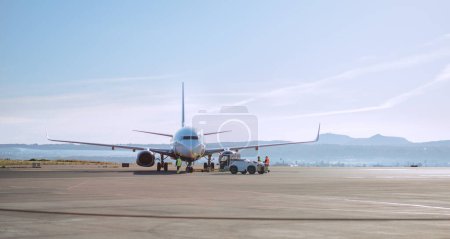 Passenger aircraft jet pushback transporting big plane using Towbarless tractor by airport personnel in Palma de Mallorca Airport, Spain.