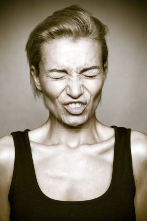 Photo for Disgusted expression on the young woman's face. - Royalty Free Image