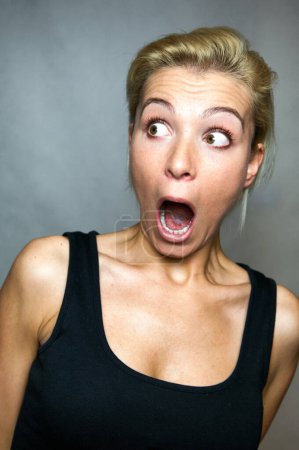 Photo for Shocked expression with open mouth on the young woman's face. - Royalty Free Image