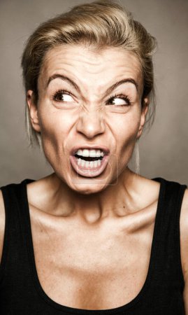 Photo for Angry expression on the young woman's face. - Royalty Free Image