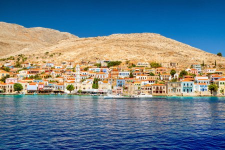 Foto de Halki, Greece - July 6, 2022: Port in  island Halki (Chalki) in Aegean sea, part of Dodecanese islands in Greece - Imagen libre de derechos