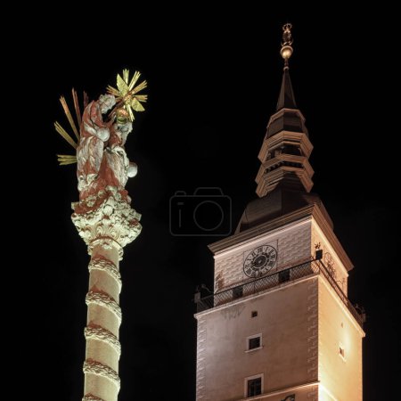 Téléchargez les photos : Trnava, Slovaquie - 18 mars 2023 : Colonne de plaque et tour de la ville sur la place Sainte-Trinité à Trnava - en image libre de droit