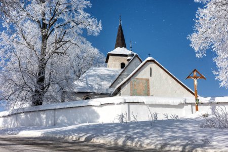Photo for Snowy country and Gothic church of All Saints in village Ludrova, Slovakia - Royalty Free Image