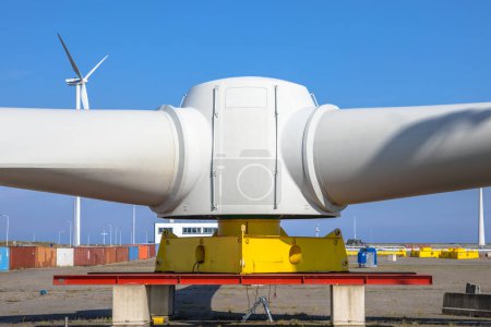 Photo for Giant rotors of wind turbine on windmill construction yard to build windfarms at sea, under blue sky - Royalty Free Image