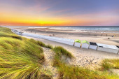 Beach houses on Westkapelle beach seen from the dunes in Zeeland at sunset, Netherlands. Landscape scene of nature in Europe. Stickers #653937254