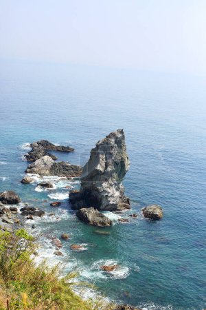 Photo for The Kamitate-gami-iwa is a rocky outcrop located in Nushima, Minamiawaji City, Hyogo Prefecture. It stands approximately 30 meters tall and is renowned as one of the Awaji Eight Views and Awaji Hundred Views. - Royalty Free Image