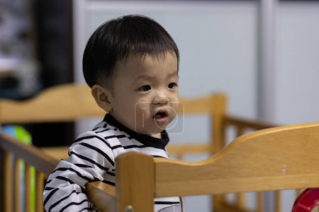 Photo for Portrait image of Adorable and happy Chinese baby boy child on baby bed - Royalty Free Image