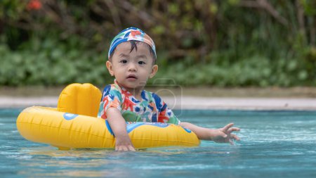 Photo for Boy enjoying playing water on pool - Royalty Free Image