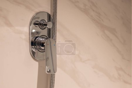 Photo for New metal water faucet on white tile wall - Royalty Free Image