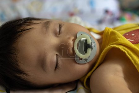 Photo for Portrait image of 1 to 2 years old childhood child. Lovely Cute Asian Chinese baby boy sleeping. - Royalty Free Image