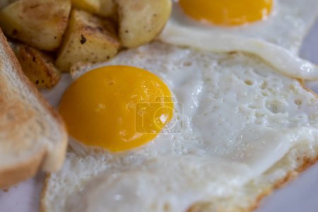 Photo for Preparation Morning breakfast with fried eggs and sausages serve on plate. - Royalty Free Image