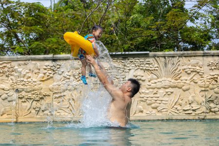 Photo for Happy Asian kids with father playing on swimming pool - Royalty Free Image