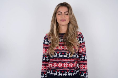 Photo for Beautiful blonde woman wearing knitted christmas sweater nice-looking sweet charming cute attractive lovely winsome sweet peaceful closed eyes - Royalty Free Image
