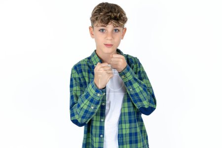 Photo for Handsome teen boy wearing plaid shirt over white background ready to fight with fist defense gesture, angry and upset face, afraid of problem. - Royalty Free Image