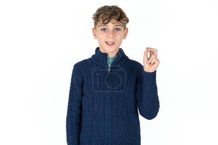 Photo for Handsome Caucasian teen boy in blue sweater pointing up with hand showing up seven fingers gesture in Chinese sign language Q. - Royalty Free Image