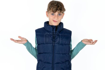 Photo for Careless attractive Handsome Caucasian teen boy in blue vest shrugging shoulders, oops. - Royalty Free Image