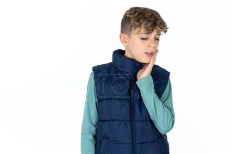 Photo for Handsome Caucasian teen boy in blue vest with toothache - Royalty Free Image