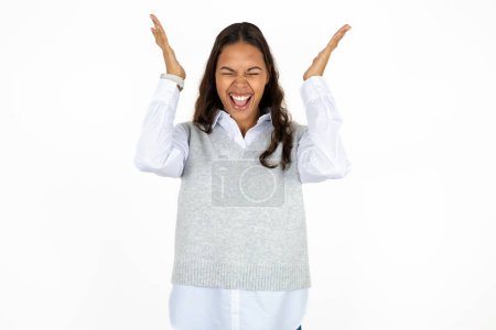 Photo for Young beautiful hispanic woman over white background goes crazy as head goes around feels stressed because of horrible situation - Royalty Free Image