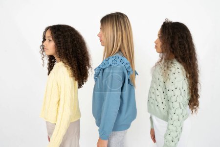 Photo for Three young beautiful multiracial kid girls looking to side, relax profile pose with natural face with confident smile. - Royalty Free Image