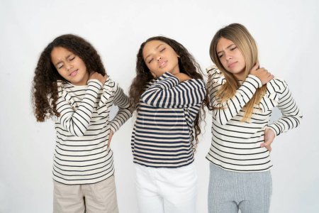 Foto de Tres jóvenes hermosas niñas multirraciales tienen dolor de espalda - Imagen libre de derechos