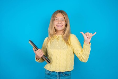 Photo for Beautiful kid girl wearing yellow sweater showing up number six Liu with fingers gesture in sign Chinese language - Royalty Free Image
