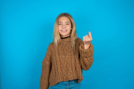 Photo for Beautiful kid girl wearing brown knitted sweater pointing up with hand showing up seven fingers gesture in Chinese sign language Q. - Royalty Free Image