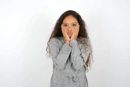 Photo for Beautiful teen girl wearing grey dress over white background Tired hands covering face, depression and sadness, upset and irritated for problem - Royalty Free Image