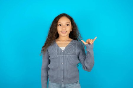 Photo for Beautiful kid girl wearing casual jacket over blue background showing up number six Liu with fingers gesture in sign Chinese language - Royalty Free Image