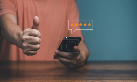 Hands of Client holding and giving a Five Star Rating feedback and raisd thumbs up, Customer Experience Concept, Best Excellent Services for Satisfaction.  