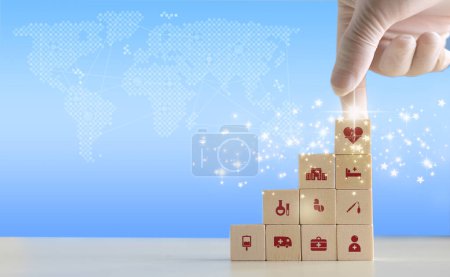 Photo for Doctor arranging and stacking wooden block cubes with printed screen health care and medical icons for the concept of health and wellness. Hand-arranging a wood block with a medical icons. - Royalty Free Image