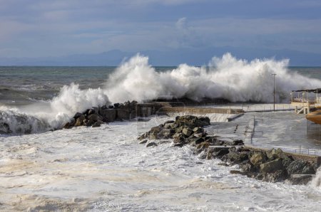 Photo for Rough sea with big waves on the piers of the Genoa seafront, Italy - Royalty Free Image