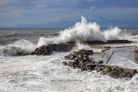 Photo for Rough sea with big waves on the piers of the Genoa seafront, Italy - Royalty Free Image