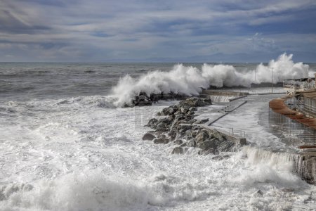 Téléchargez les photos : Mer agitée avec de grandes vagues sur les jetées du front de mer de Gênes, Italie - en image libre de droit