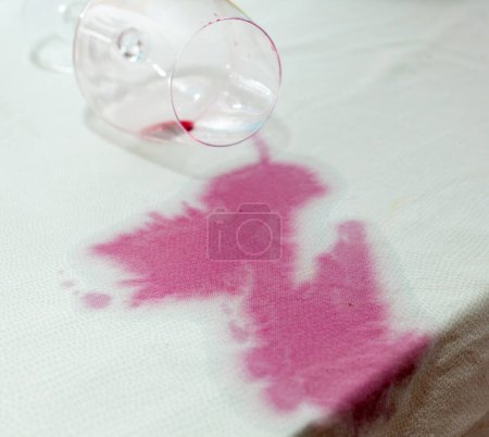 Foto de Bodega derramada con mancha roja en mantel - Imagen libre de derechos