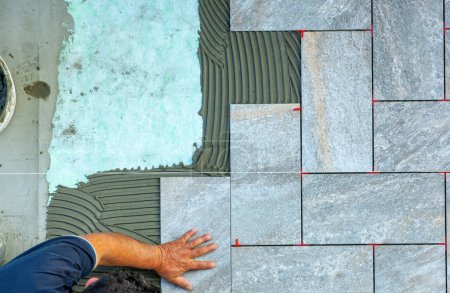 Photo for Top view of a tiler working in a garden. - Royalty Free Image