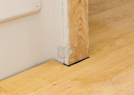 Photo for Detail of the parquet installation near the door frame. - Royalty Free Image