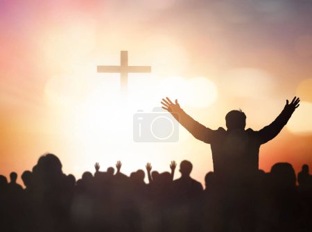 Photo for Easter and Good Friday concept,Silhouette human raising hand to praying God on blurred cross  sunset background - Royalty Free Image