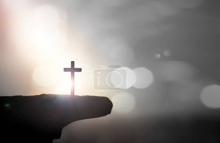 Photo for Christian holding the Holy Cross of Jesus Christ on sunset background - Royalty Free Image